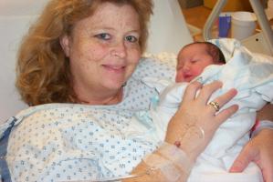 Anne is all smiles with her little bundle of joy